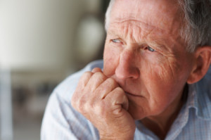 Closeup of an elderly man looking away in deep thought